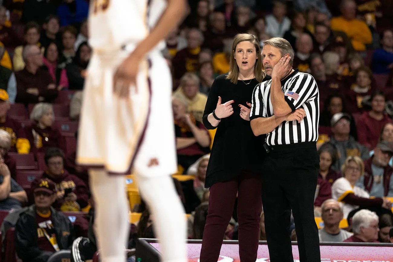 Exhibit 14.7 Negotiating with the Referee Minnesota Gophers coach, Lindsay Whalen talks to a referee during a University of M