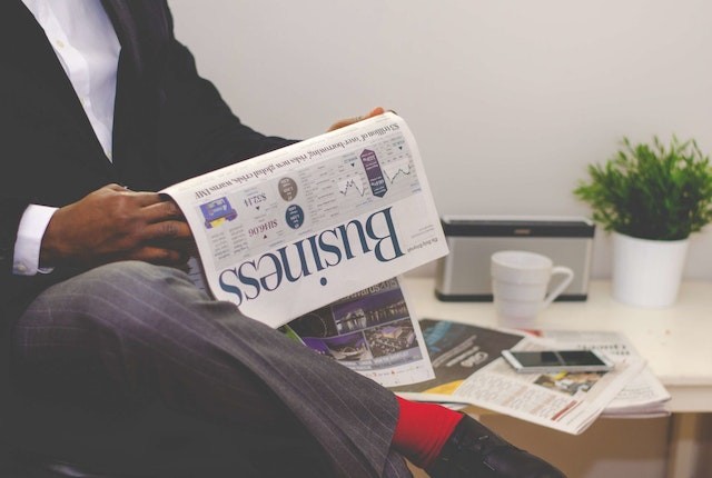 Man reading newspaper.