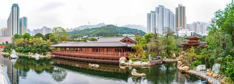 Figure 2.5 Wide panorama of a traditional Chinese pavilion and pond in a garden, contrasted with high-rise city buildings.