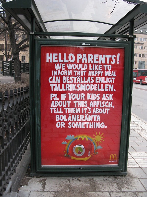 Figure 4.4 A McDonald's bus stop ad with a humorous red sign that mixes English and Swedish text, addressed to parents.