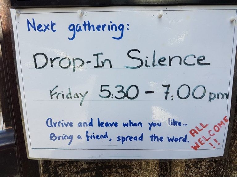 A whiteboard which reads:Next gathering: Drop-In Silence Friday 5:30-7:00pm     Arrive and leave when you like...bring a friend, spread the word.