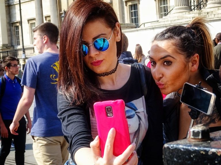  Two people talking a close-up selfie in London