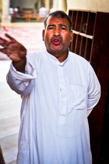  A man tells tourists to go away after they refuse to pay to enter the Mosque of Salih Tala'i, which is free to enter