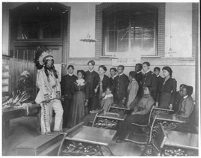 Louis Firetail (Sioux, Crow Creek), wearing tribal clothing, in American history class, Hampton Institute, Hampton, Virginia