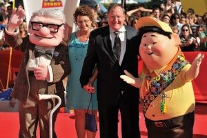 John Lasseter on the red carpet with life size figures of main characters Carl and Russell