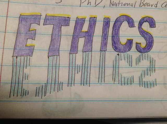 Handwritten word ETHICS in purple block letters with a dashed shadow effect on lined notebook paper.