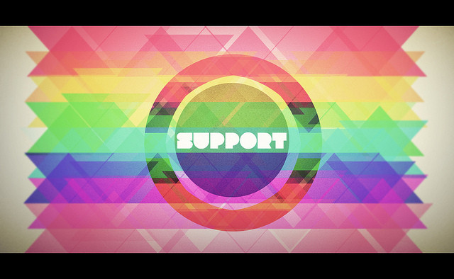 Geometric graphic with colorful rainbow gradients and a central circle enclosing the stylized word SUPPORT.